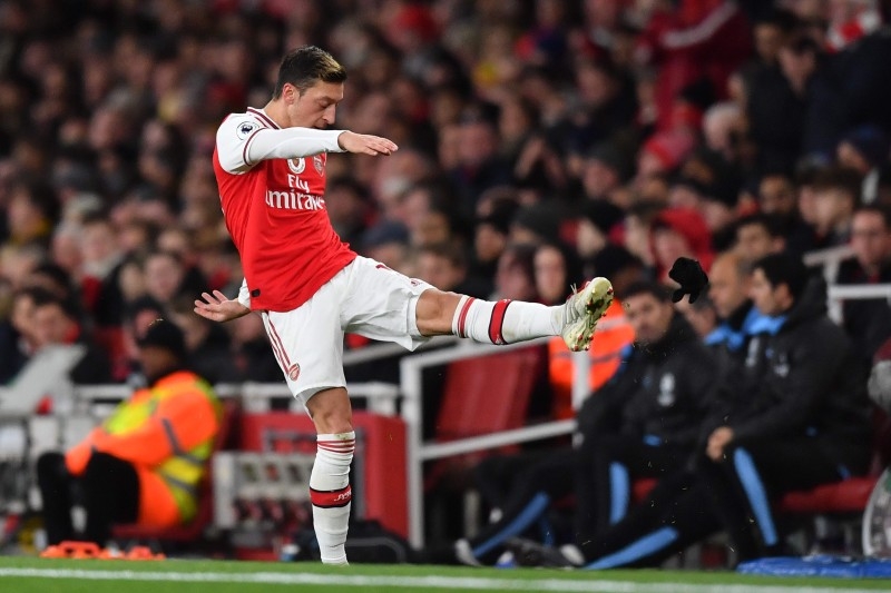 Arsenal's German midfielder Mesut Ozil reacts to his substitution by kicking his gloves along the touchline during the English Premier League football match between Arsenal and Manchester City at the Emirates Stadium in London in this Dec. 15, 2019 file photo. — AFP
