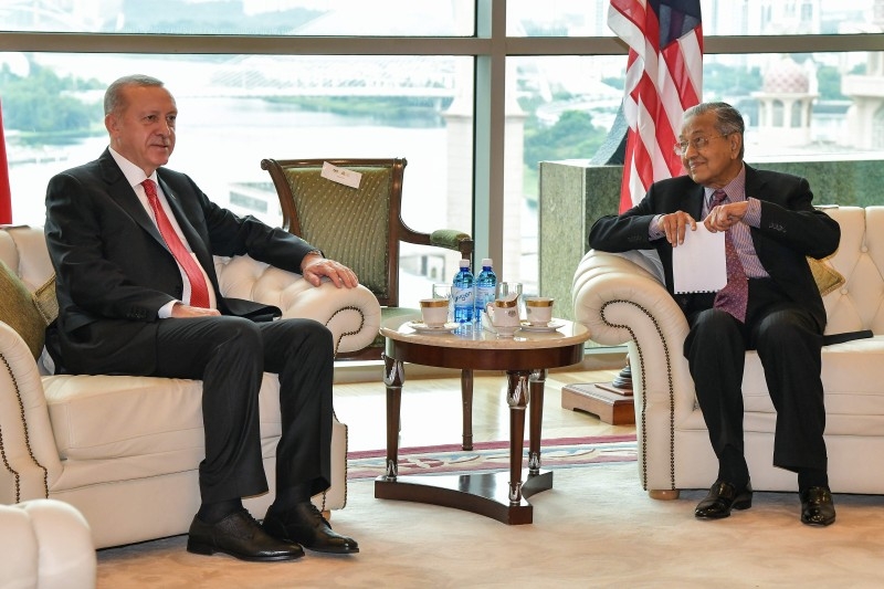 Malaysia's Prime Minister Mahathir Mohamad (right) and Turkey's President Recep Tayyip Erdogan talk before their meeting on Wednesday in Putrajaya. — AFP