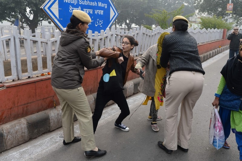 Police detain women at a demonstration against India’s new citizenship law in New Delhi on Thursday. — AFP