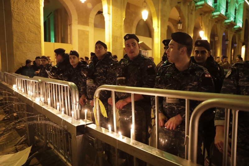 Lebanese security forces stand guard behind a barricade during ongoing anti-government demonstrations in the capital Beirut's downtown district on Wednesday. — AFP