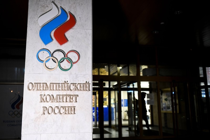 In this file photograph taken on Dec. 9, 2019, a pedestrian walks out of the Russian Olympic Committee (ROC) headquarters in Moscow. Russia's anti-doping agency will formally contest the country's four-year ban from sporting events over doping violations, the head of the body's supervisory board said on Thursday. 