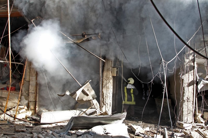 Smoke billows from a building following a reported bombardment by pro-Syrian government forces in the town of Maaret Al-Numan in Syria's Idlib province, the country's last major opposition bastion, on Friday. — AFP