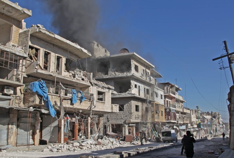 Smoke billows from a building following a reported bombardment by pro-Syrian government forces in the town of Maaret Al-Numan in Syria's Idlib province, the country's last major opposition bastion, on Friday. — AFP