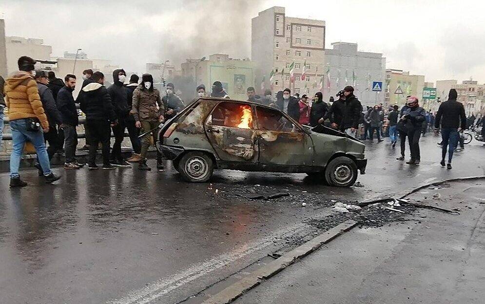 Iranian protesters gather around a burning car during a demonstration against an increase in gasoline prices in the capital Tehran in this Nov. 16, 2019 file photo. — AFP