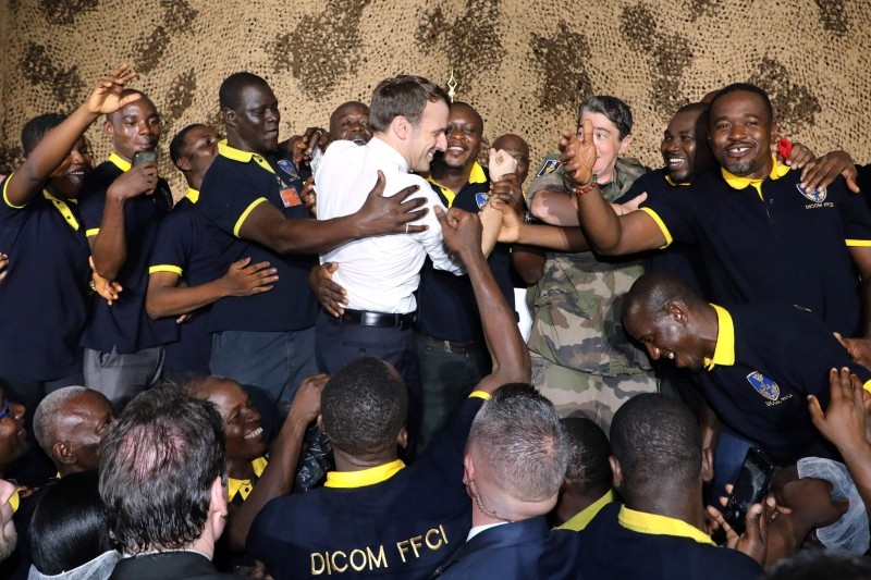 French President Emmanuel Macron celebrates his 42nd birthday with French soldiers during a Christmas dinner with French troops at the Port-Bouet military camp near Abidjan on Friday. -AFP