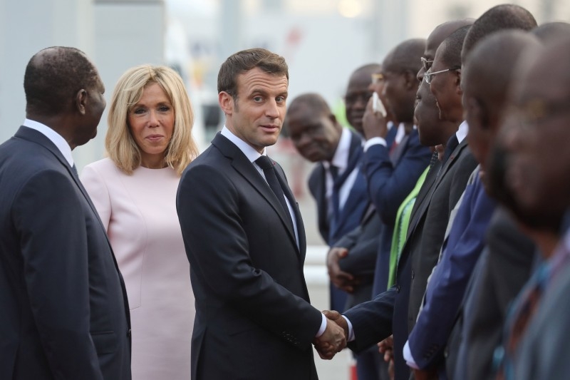 French President Emmanuel Macron celebrates his 42nd birthday with French soldiers during a Christmas dinner with French troops at the Port-Bouet military camp near Abidjan on Friday. -AFP