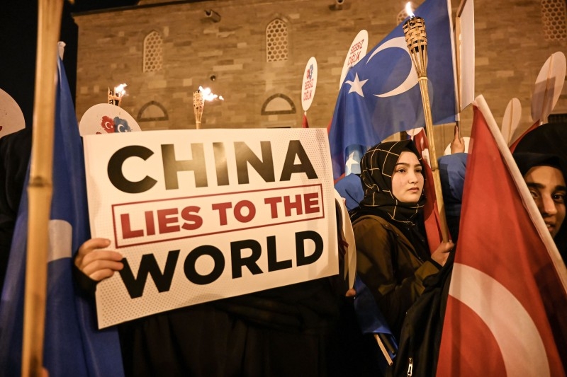 Supporters of China's Muslim Uighur minority wave flag of East Turkestan and hold placards Friday during a demonstration at Fatih in Istanbul.  -AFP