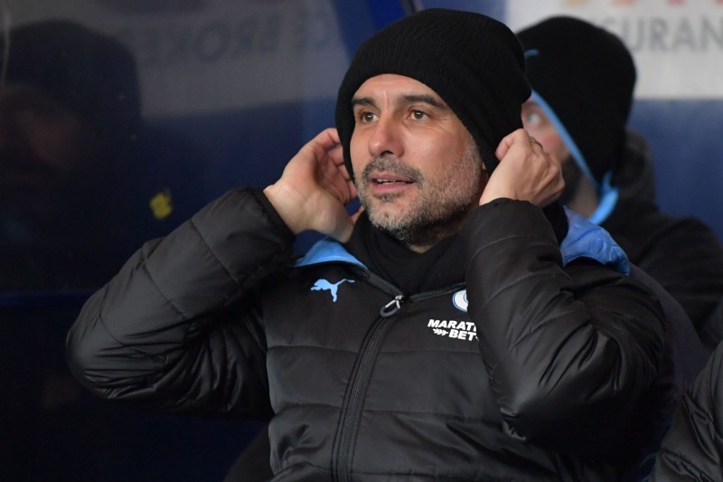 Manchester City's Spanish manager Pep Guardiola takes his seat for the English League Cup quarterfinal football match between Oxford United and Manchester City at the Kassam Stadium in Oxford, west of London, on Dec. 18, 2019. — AFP