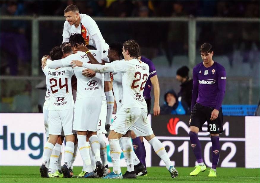 Roma players celebrate afters scoring a goal against Fiorentina in the Italian League encounter. — AFP