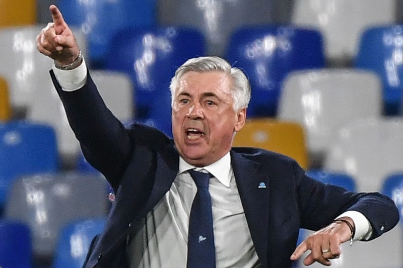 Everton's Italian head coach Carlo Ancelotti (L) chats to Everton's English chairman Bill Kenwright at the English Premier League football match between Everton and Arsenal at Goodison Park in Liverpool, north west England on Saturday. — AFP