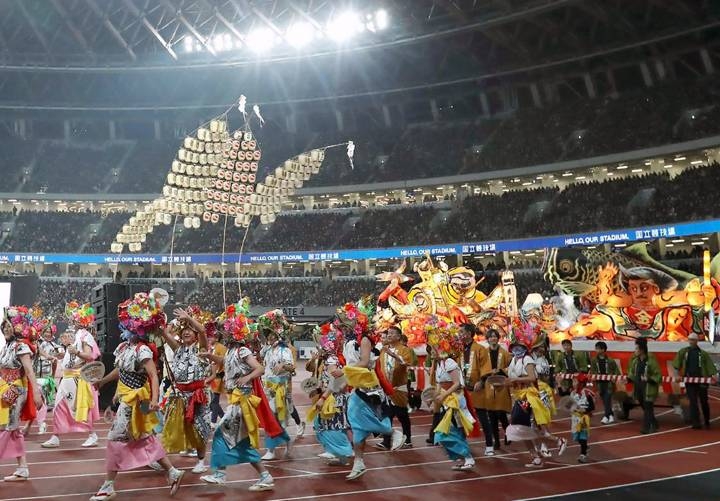 Performers participate in festival costumes of Tohoku region or Northeast Japan during the opening event for the new National Stadium, venue for the upcoming Tokyo 2020 Olympic Games, in Tokyo on Saturday.  — AFP