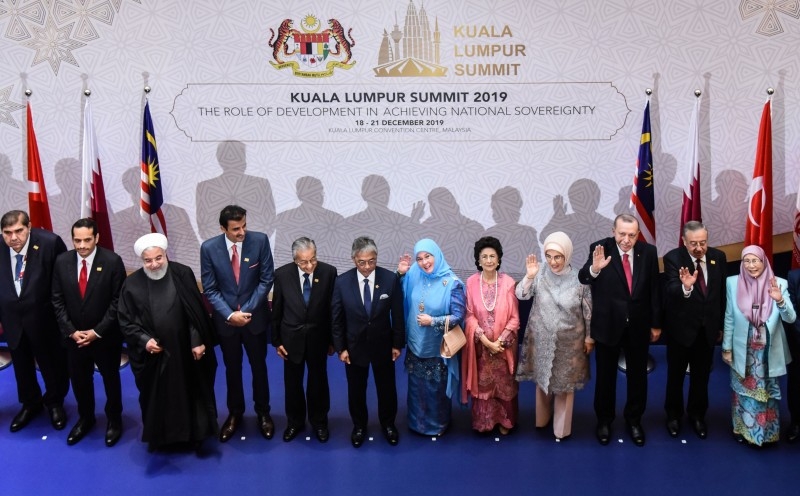 This handout from Malaysia's Department of Information taken and released on Dec.19, 2019 shows Iran's President Hassan Rouhani (3rd L), Emir of Qatar Sheikh Tamim bin Hamad al-Thani (4th L), Malaysia's Prime Minister Mahathir Mohamad (5th L), Malaysia's King Sultan Abdullah Sultan Ahmad Shah (6th L), Malaysia's Queen Tunku Azizah Aminah Maimunah Iskandariah (6th R), Siti Hasmah Mohamad Ali (5th R), wife of Malaysia's Prime Minister Mahathir Mohamad, Emine Erdogan (4th R), wife of Turkey's President Recep Tayyip Erdogan (3rd R) and Malaysia's Deputy Prime Minister Wan Azizah Wan Ismail (R) posing for a photo before the opening ceremony of the Kuala Lumpur Summit 2019 in Kuala Lumpur. AFP
