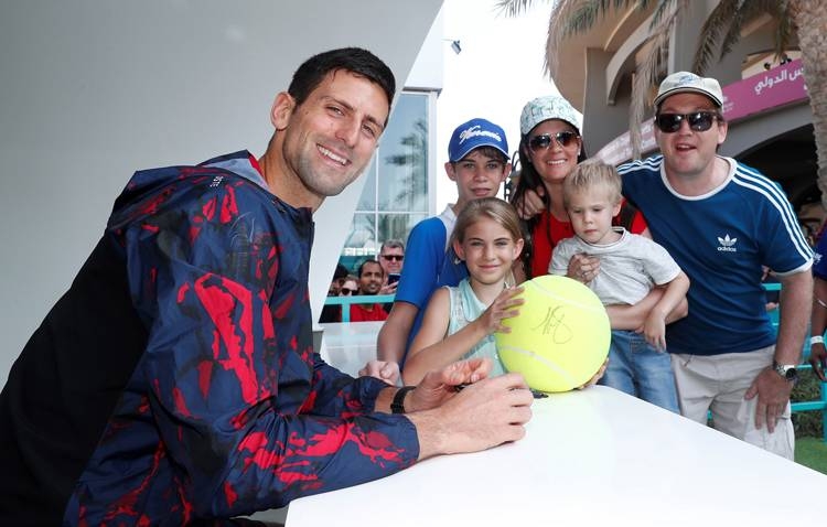Novak Djokovic wth fans during an autograph signing session in Abu Dhabi.