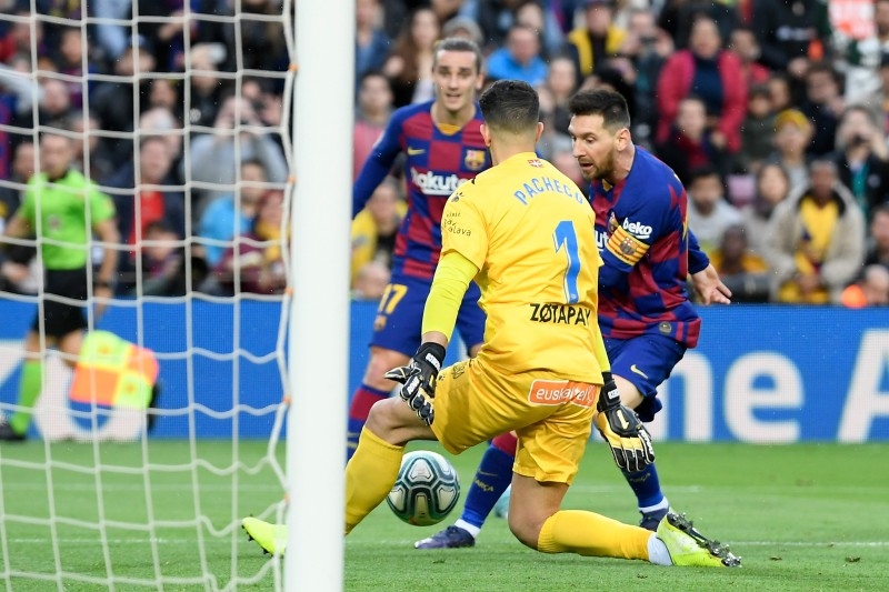 Barcelona's Argentine forward Lionel Messi (R) challenges Alaves' Spanish goalkeeper Fernando Pacheco during the Spanish league football match FC Barcelona against Deportivo Alaves at the Camp Nou stadium in Barcelona on Saturday. — AFP