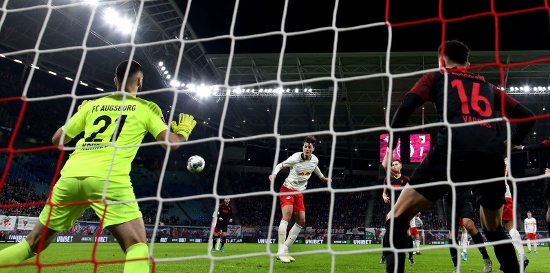 Leipzig's Czech forward Patrik Schick (C) heads home for the 2-1 lead against Augsburg's as Czech goalkeeper Tomas Koubek (L) and Augsburg's midfielder Ruben Vargas (R) look on during the German first division Bundesliga football match in Leipzig, eastern Germany, on Saturday, — AFP