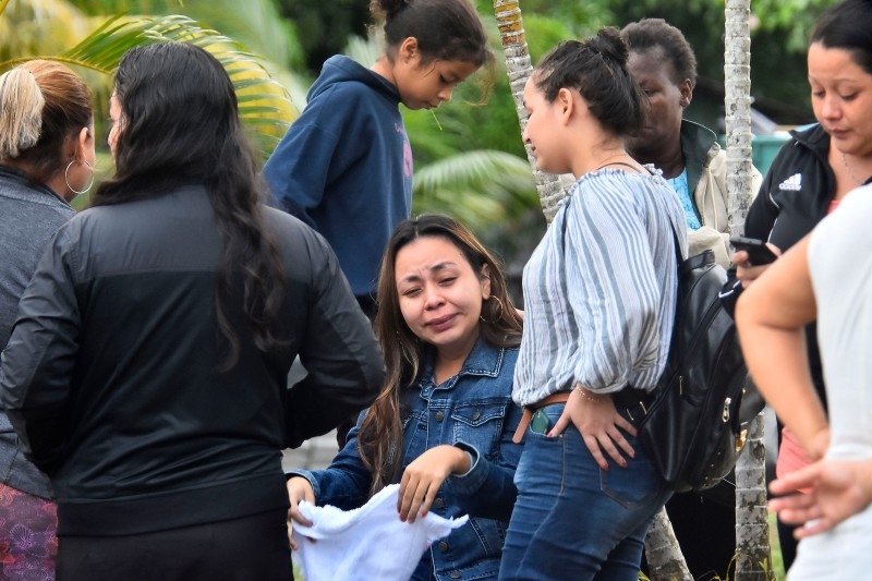 Relatives of inmates react after getting information about their loved ones in front of the penitentiary of Tela, Atlantida department, Honduras, on Saturday, following clashes occurred at the jail. -AFP