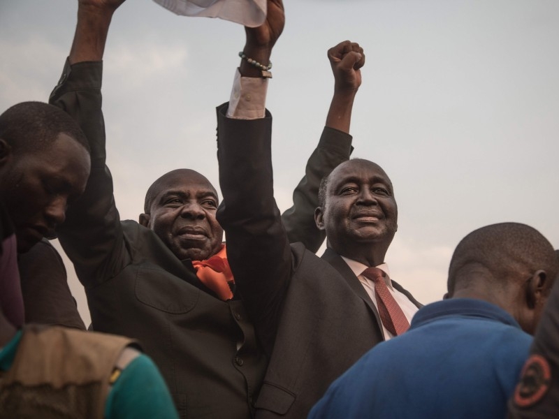 Former Centrafrica's President François Bozize (L) and National Convergence Kwa Na Kwa (KNK) party general secretary Bertin Bea (C) greet the crowd in the Boeing district of Bangui, on Saturday. AFP 