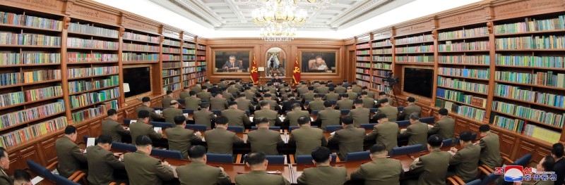 This undated handout photo released by North Korea's official Korean Central News Agency (KCNA) on Sunday shows North Korean leader Kim Jong Un (top, C) attending the Third Enlarged Meeting of the Seventh Central Military Commission of the Workers' Party of Korea (WPK) in an undisclosed location.  -AFP