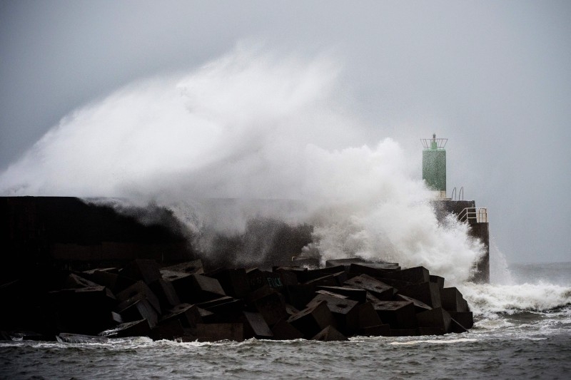 Waves hit the jetty of the port of A Guarda, northwestern Spain, during the storm Fabien, on Saturday. -AFP