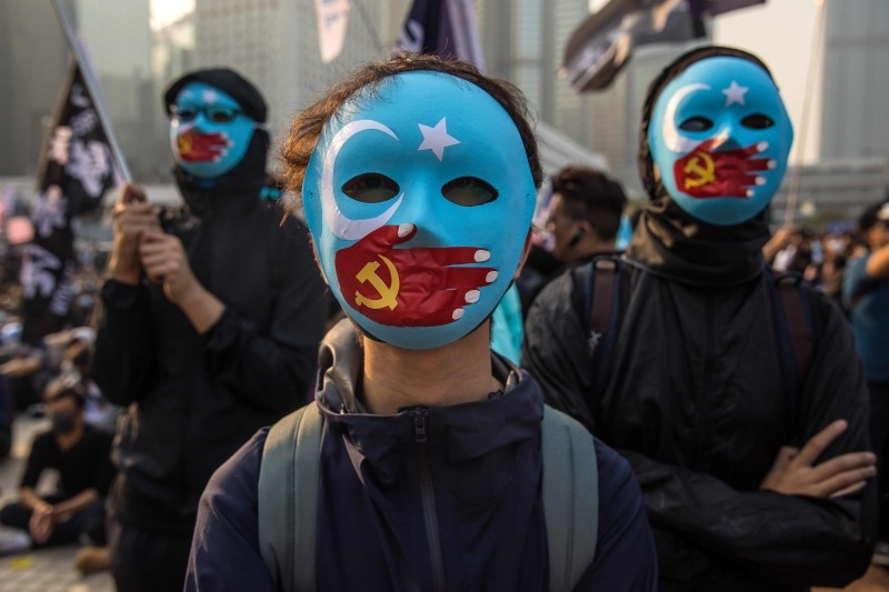 Protesters attend a rally in Hong Kong on Sunday to show support for the Uighur minority in China. -AFP