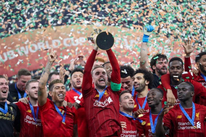 Liverpool's players lift the trophy following the 2019 FIFA Club World Cup Final football match between England's Liverpool and Brazil's Flamengo at the Khalifa International Stadium in the Qatari capital Doha on Saturday. — AFP