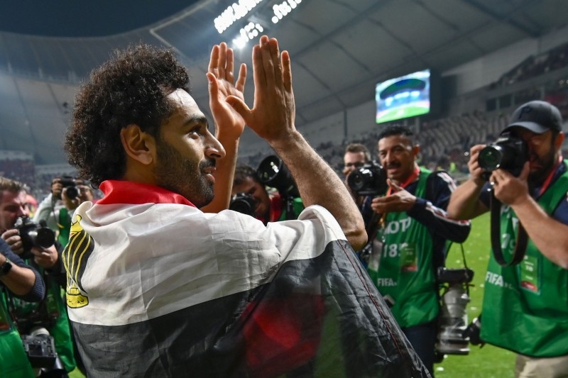 Liverpool's players lift the trophy following the 2019 FIFA Club World Cup Final football match between England's Liverpool and Brazil's Flamengo at the Khalifa International Stadium in the Qatari capital Doha on Saturday. — AFP