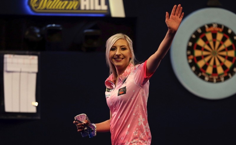 Fallon Sherrock, the first woman to win a match at the world darts championship, reached the third round with a stunning bullseye finish on Saturday and confidently predicted she could win the tournament.