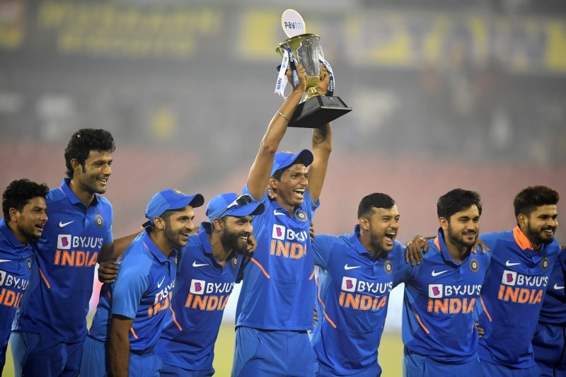 India's cricketers celebrate after winning the third One Day International cricket match of a three-match series between India and West Indies to win the series 2-1 at the Barabati Stadium in Cuttack on  Sunday. — AFP