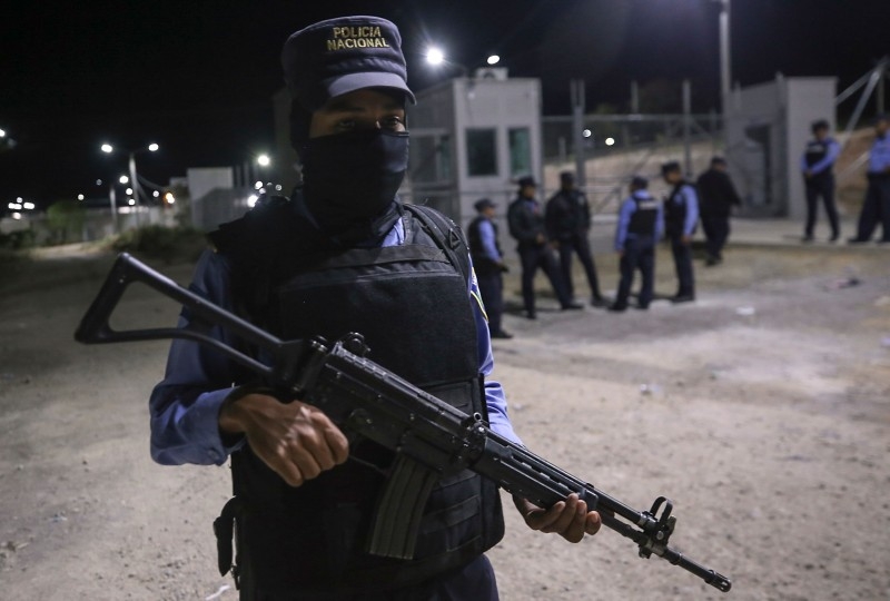 Members of Honduras' National Police patrol the entrance of El Porvenir prison, in the department of Francisco Morazan Honduras, on Sunday. -AFP