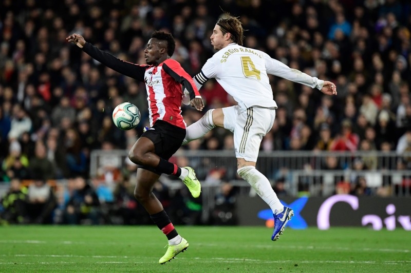 Real Madrid's Spanish defender Sergio Ramos (R) challenges Athletic Bilbao's Spanish forward Inaki Williams during the Spanish league football match at the Santiago Bernabeu stadium in Madrid on Sunday. — AFP