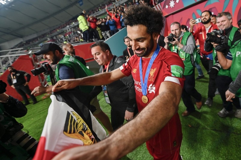 Liverpool's Egyptian midfielder Mohamed Salah greets the fans following the 2019 FIFA Club World Cup Final football match between England's Liverpool and Brazil's Flamengo at the Khalifa International Stadium in the Qatari capital Doha on Saturday. — AFP