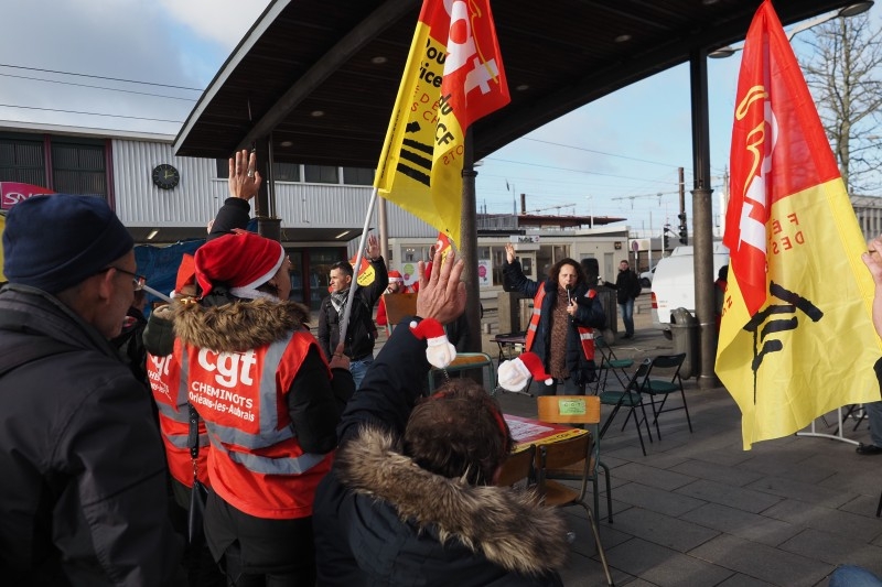 SNCF railway workers gather for their organized Christmas banquet in front of the Les Aubrais station after a meeting against the pension reform on Monday near Orleans, central France. -AFP