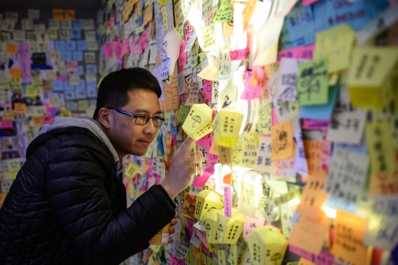 In this picture taken on December 2, 2019, newly-elected district councilor Cary Lo Chun-yu looks at a 