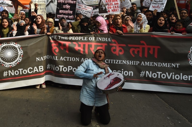 Police gather at a protest against India's new citizenship law in New Delhi on Tuesday. — AFP