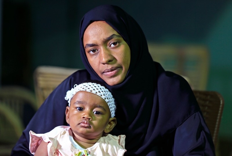 Afaf Mahmoud, widow of Mukhtar Abdallah, cradles their baby in Atbara city on the banks of the River Nile, northeast of Sudan’s capital Khartoum, in this Dec. 15, 2019 file photo. — AFP
