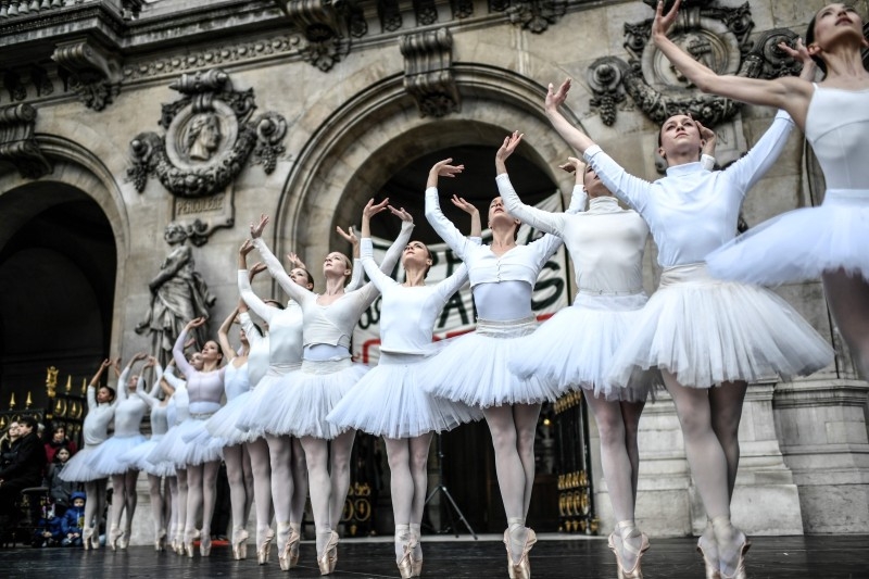  Paris Opera dancers perform in front of the Palais Garnier against the French government's plan to overhaul the country's retirement system, in Paris, on Tuesday. -AFP
