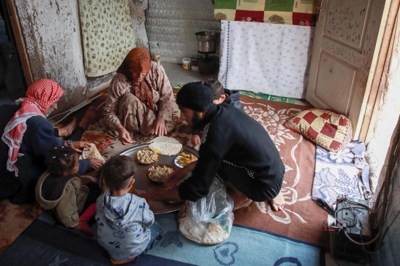 Umm Khaled carries a bowl of mushrooms in a camp in a town called Haarem in the northwestern province of Idlib, Syria, in this Nov. 29, 2019 file photo. — AFP