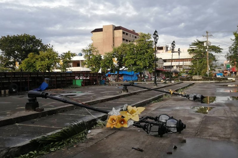 Lamp posts damaged due to typhoon Phanfone lie on a road in Ormoc City, Leyte province in central Philippines, on Wednesday. — AFP