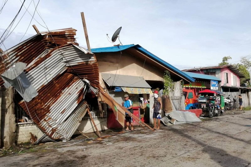 Lamp posts damaged due to typhoon Phanfone lie on a road in Ormoc City, Leyte province in central Philippines, on Wednesday. — AFP