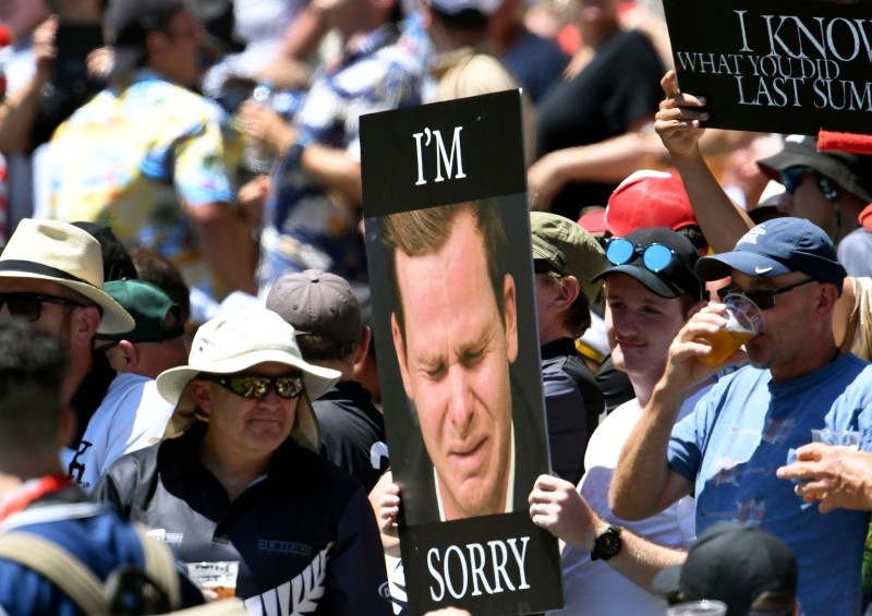 Fans hold up a placard of Australian batsman Steve Smith on the first day of the second cricket Test match against New Zealand at the MCG in Melbourne, Australia, on Thursday. — AFP
