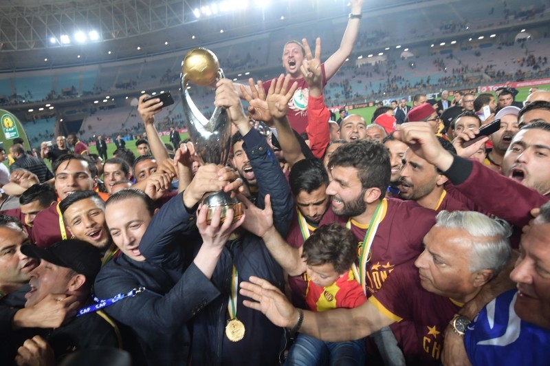 In this file photo taken on May 31, 2019 Esperance de Tunis team captain Moez ben Cherifia and Tunisian prime minister Youssef Chahed pose with a trophy after winning during the 2nd leg of CAF champion league final 2019 football match between Tunisia's Esperance sportive de Tunis and Morocco's Wydad Athletic Club at the Olympic stadium in Rades. — AFP
