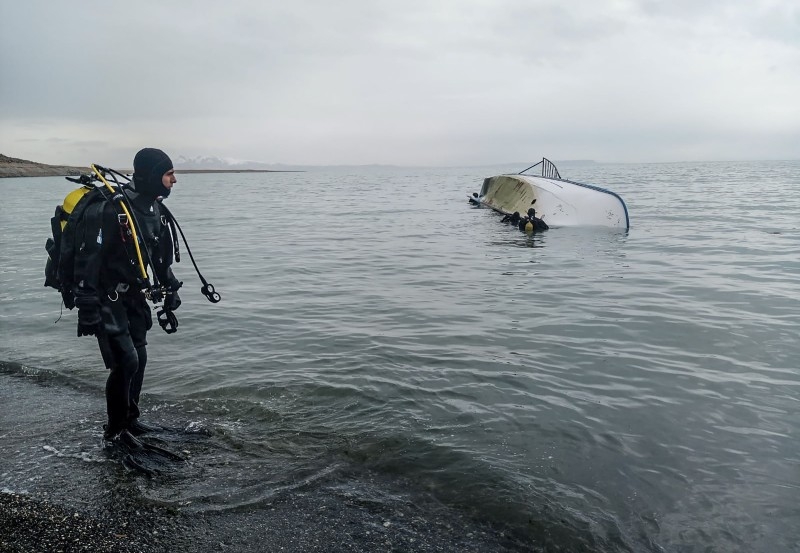A rescue diver stands on the shores of Lake Van after a boat carrying refugees and migrants sank in eastern Turkey on Thursday. — AFP