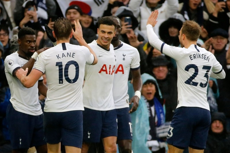Tottenham Hotspur's English midfielder Dele Alli (C) celebrates with teammates after he scores his team's second goal during the English Premier League football match against Brighton and Hove Albion at Tottenham Hotspur Stadium in London, on Thursday. — AFP