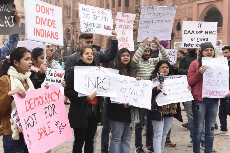 Students protest as they hold placards and shout slogans during a demonstration against India's new citizenship law in Amritsar on Friday. Mobile Internet was cut in parts of India's most populous state and thousands of riot police were deployed as authorities readied for fresh protests over a citizenship law seen as anti-Muslim. — AFP