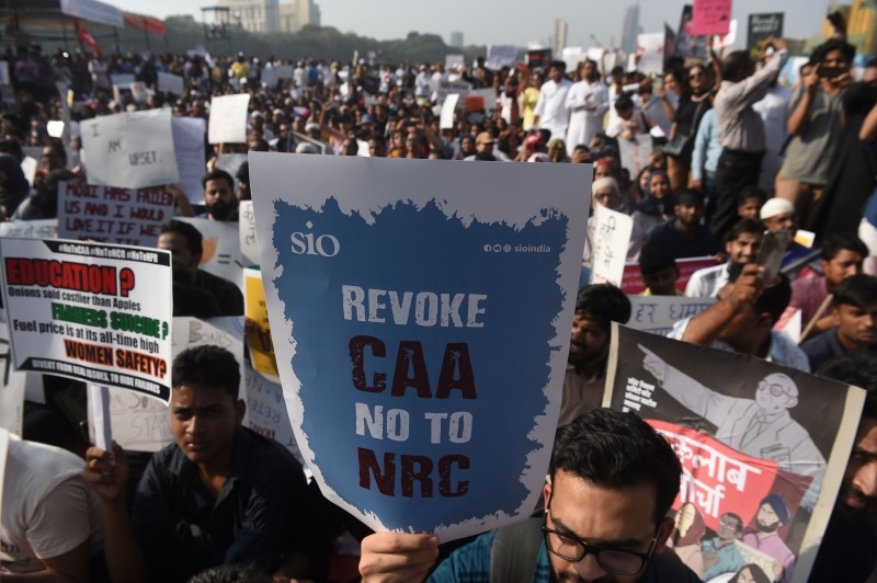 Protesters hold placards during a demonstration against India's new citizenship law in Mumbai on Friday. — AFP