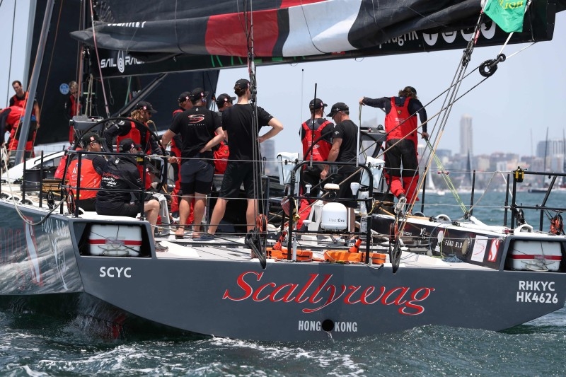 Photo shows Hong Kong Dovell 100 yacht SHK Scallywag sailing out of Sydney harbor at the start of the Sydney to Hobart yacht race on Friday. — AFP