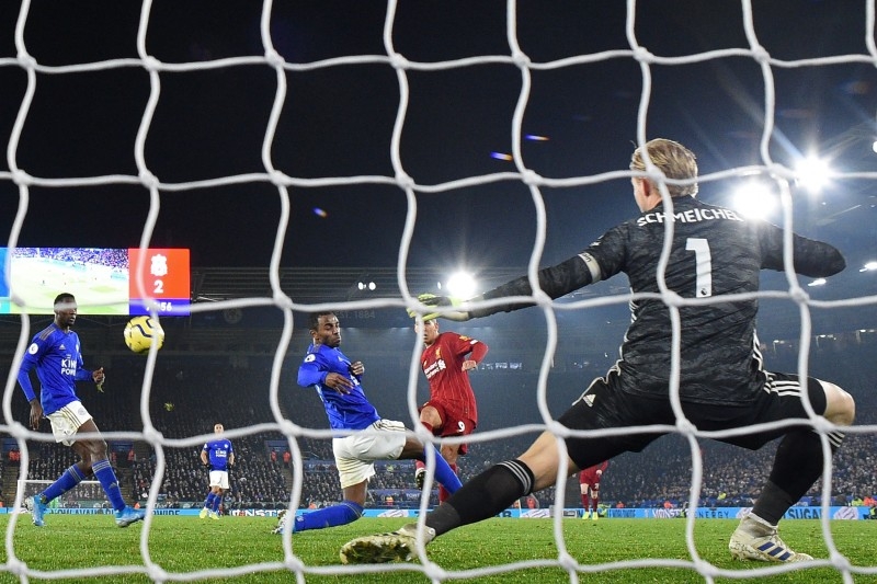 Liverpool's Brazilian midfielder Roberto Firmino (C) shoots to score their third goal during the English Premier League football match against Leicester City at King Power Stadium in Leicester, central England on Thursday. Liverpool won the game 4-0.  — AFP