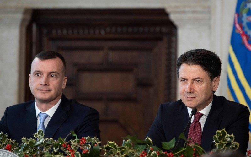 Italy's Prime Minister Giuseppe Conte (R), flanked by his spokesman Rocco Casalino (L), speaks during the end-of-year press conference in Rome, on Saturday. — AFP