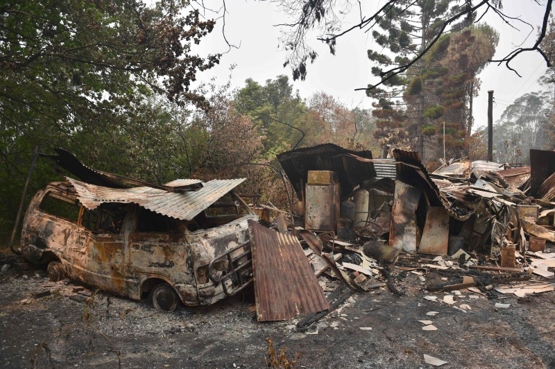 A house and van are seen destroyed after bushfires ravaged the town of Bilpin, 70km west of Sydney  on Saturday. -AFP