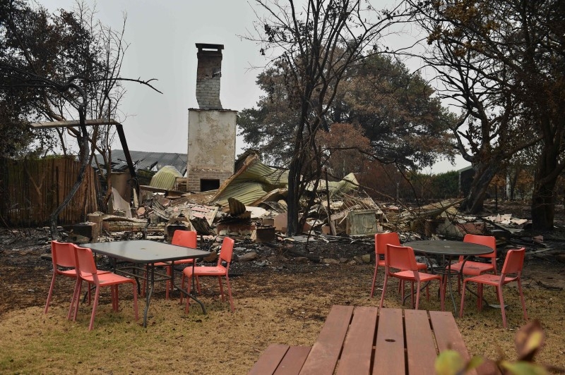 A house and van are seen destroyed after bushfires ravaged the town of Bilpin, 70km west of Sydney  on Saturday. -AFP